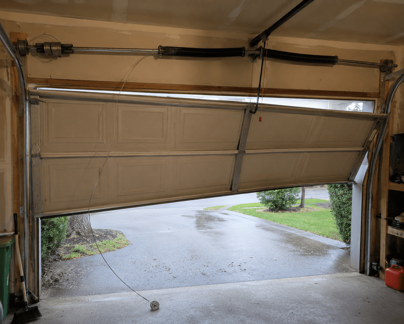 Broken garage door cable and exposed hardware 