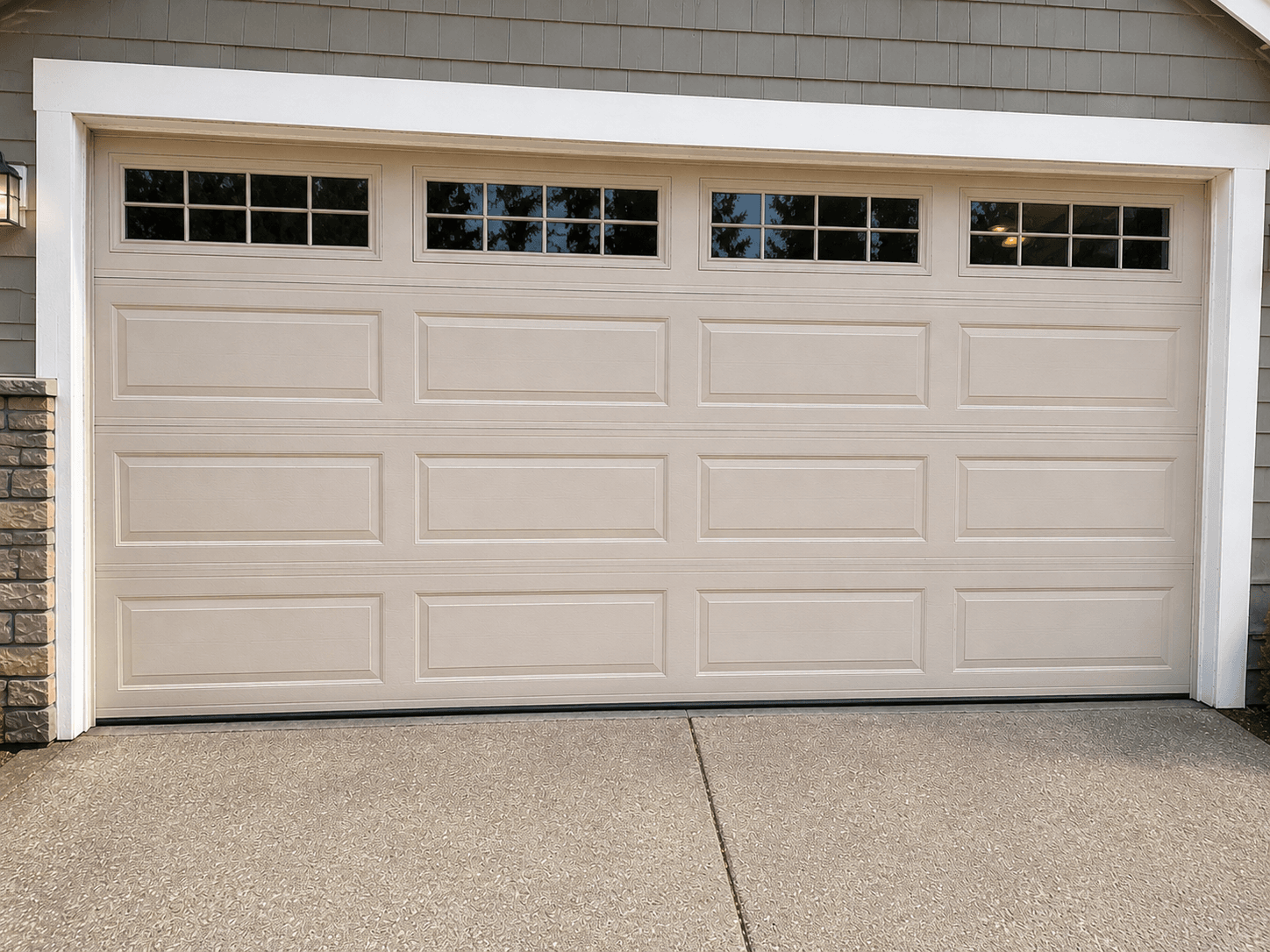 Completed garage door panel repair with a seamlessly matched replacement panel at a residential home near Prairie Ridge.