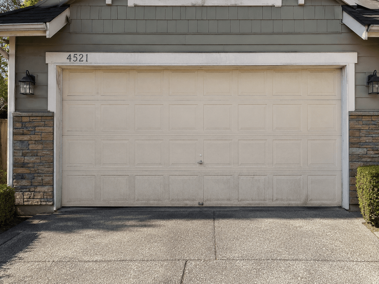 Existing garage door before installation of a new insulated residential garage door at a home in Tehaleh