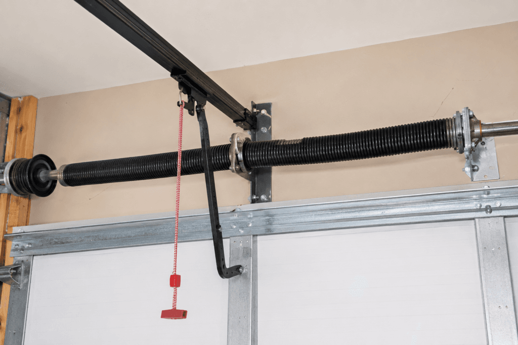 Garage door torsion spring repair showing a newly installed spring system above a residential garage door in South Hill.